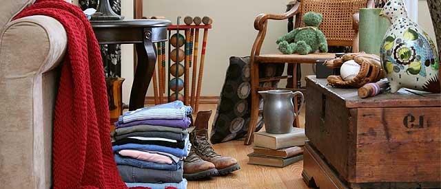 a living room with furniture, blankets and decorations.